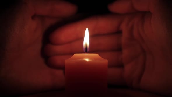 Candle Burning on a background of palm