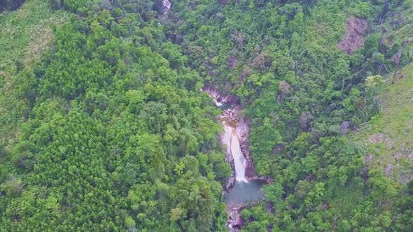 Drone Flies High Above Green Hills with River Waterfalls