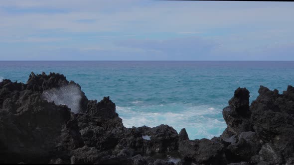 Waves crashing into shore on Hawaii