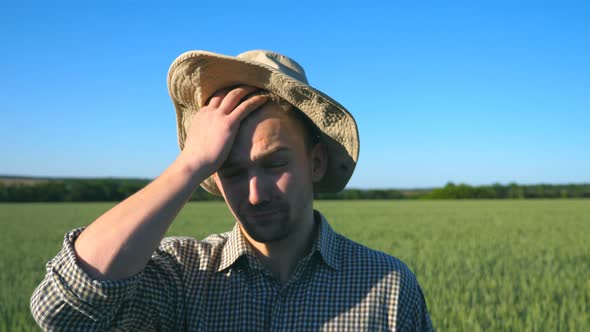 Portrait of Confused Male Farmer Looking Into the Camera and Scratching His Head. Close Up of Young