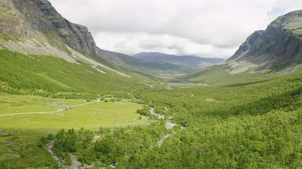 Stunning Landscape Of Mountain Pass With Lush Green Meadow and Stream At Daytime In Hydalen Valley,