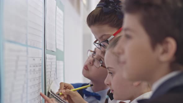 Children Looking at Timetable on First Day at School