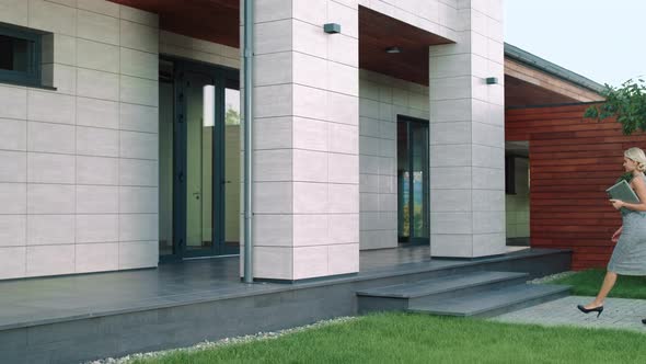 Business Woman Entering Office Building. Elegant Woman Going Up Stairs