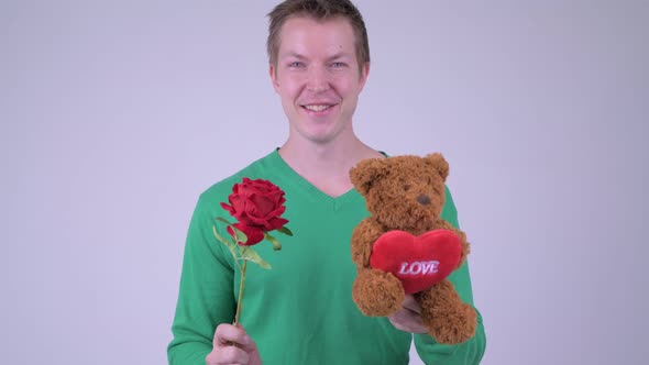 Happy Young Handsome Man with Rose and Teddy Bear Ready for Valentine's Day