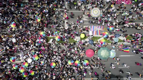 cenital drone shot of a crowd waving the gay pride flag at the pride parade in mexico city during ju