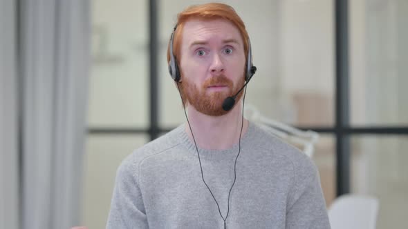 Beard Redhead Man Talking Through Headset with Mic