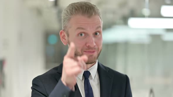 Portrait of Assertive Businessman with Pointing at the Camera