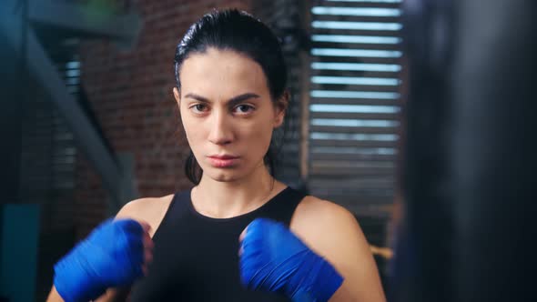 Closeup Beauty Asian Woman Fighter of Mixed Martial Arts Near Punching Bag Preparing to Workout