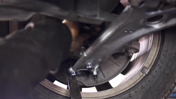 Changing The Car Undercarriage Suspension Arm In The Repair Shop