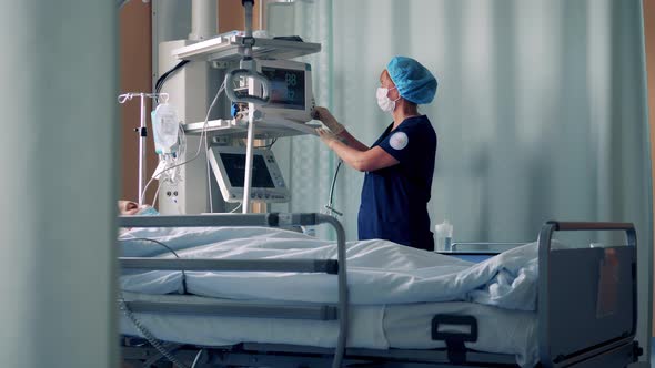 A Nurse is Managing Patient Monitors in a Hospital Ward