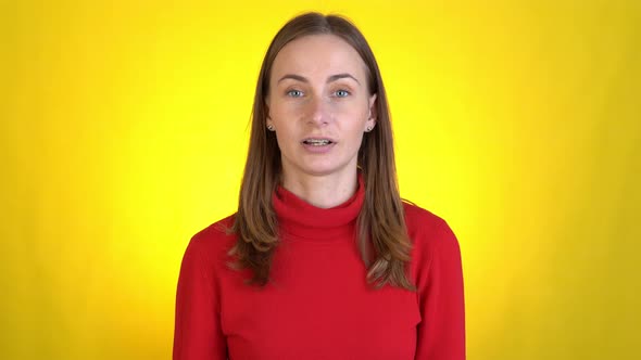 Woman Coach Teacher Talking Looking at Camera on a Yellow Background