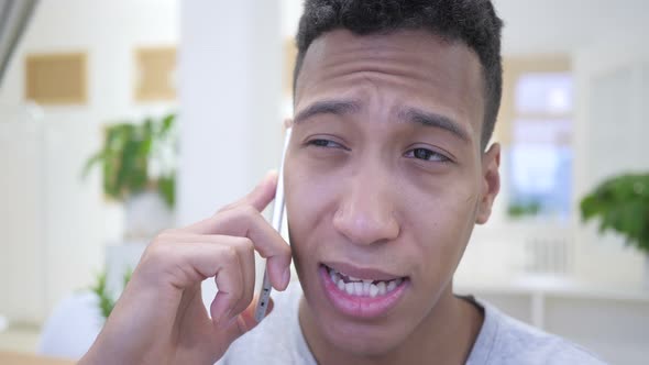 African Young Man Talking on Smartphone