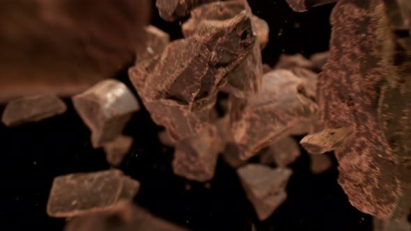 Super Slow Motion Detail Shot of Raw Chocolate Chunks Flying Towards Camera at 1000Fps