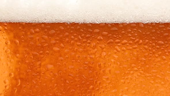 Close up background of beer with bubbles in glass