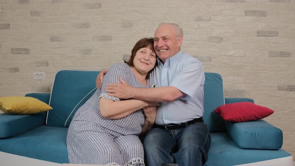 Senior Couple After Finding Out Good News They Smile and Embrace Each Other.