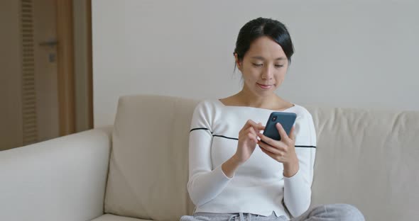 Woman use of mobile phone at home