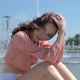 Portrait of Beautiful Girl in Colorful Summer Clothes Sitting Near a Fountain - VideoHive Item for Sale