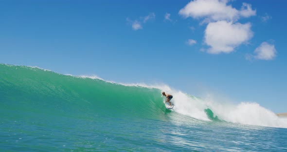 Surfer getting barreled riding epic wave