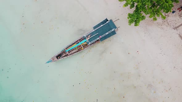 Aerial view of top down picture of colorful wooden boats. Boats at the pier and noise cloud.