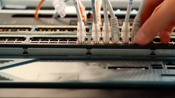 IT Engineer Patching Network Equipment In Server Room. Network Engineer Maintenance Work In Server.