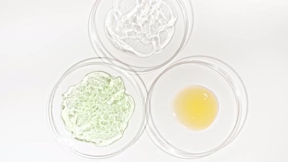 Rotation of Petri Dishes with Cosmetics Samples on a White Background alt