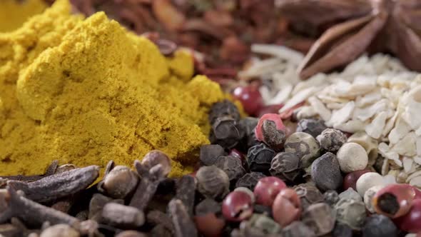 Spices and Herbs Rotate on a Stone Background