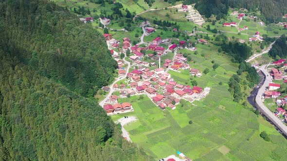 aerial top down view of a small village in Uzungol Trabzon with homes covered in red roofs and large