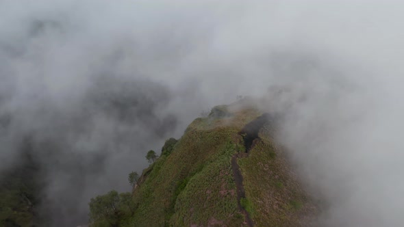 Close Up Tilting Aerial View of a Broken Surface at the Top of a Mountain Ridge on an Active Volcano