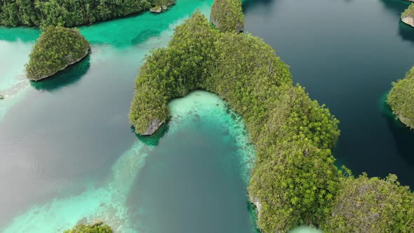 Aerial View Of Triton Bay With Turquoise Sea And Green Tropical Trees In Kaimana Islands. 