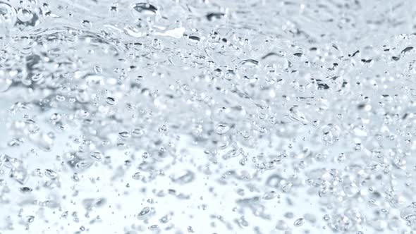 Super Slow Motion Shot of Clear Water Wave And Bubbles Isolated on White Background at 1000Fps