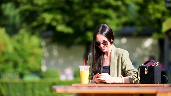 Young Woman Eating Take Away Noodles on the Street