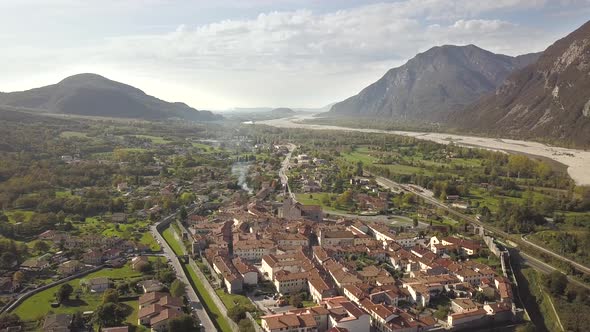 Aerial view of a small historic town Venzone in Northern Italy with red tiled roofs of old buildings