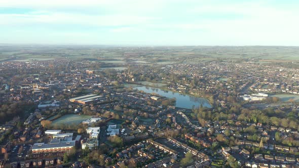 Aerial view of a city with its cathedral and a lake in the early morning