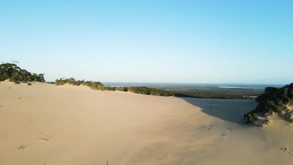 High drone view looking over the unique "moonscape" sand mass of the Carlo Sand Blow Rainbow Beach A