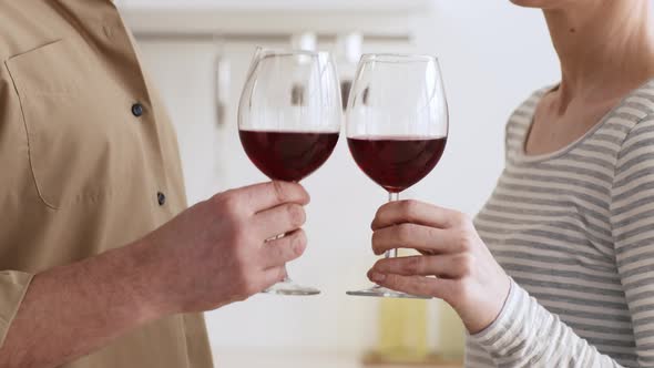 Unrecognizable Spouses Drinking Red Wine And Clinking Glasses Indoors Cropped