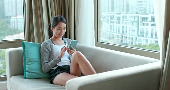 Woman using cellphone at home 