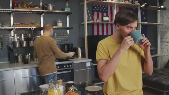 Cheerful Man Drinking Coffee and Smiling for Camera