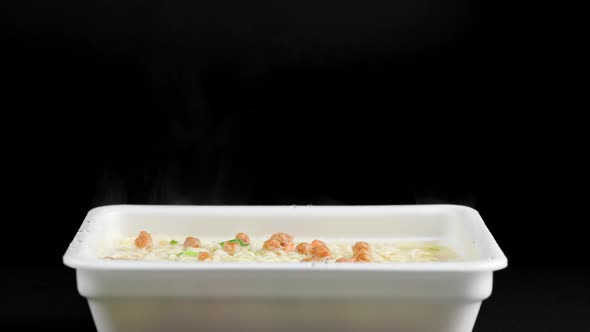 Steam Rising From Cooking Instant Noodles in Styrofoam Tray Container During Cooking