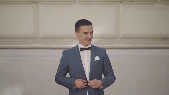 Handsome Groom Fixes His Jacket. Wedding Day. Slow Motion
