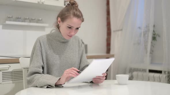 Successful Woman Reading Documents and Celebrating