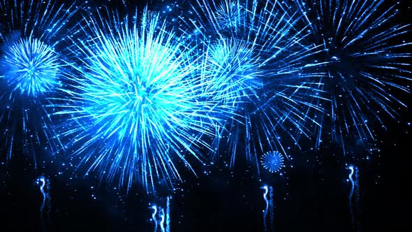 Blue big shiny fireworks bokeh lights in the night sky firework show.