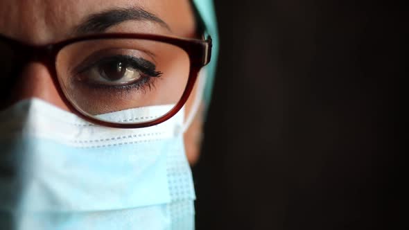 Young female medic, wearing a mask and glasses