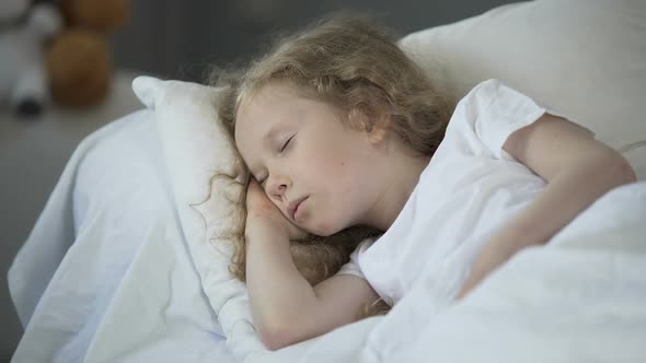 Blond Little Girl Sleeping in Comfortable Bed at Home, Calm Rest for Good Health