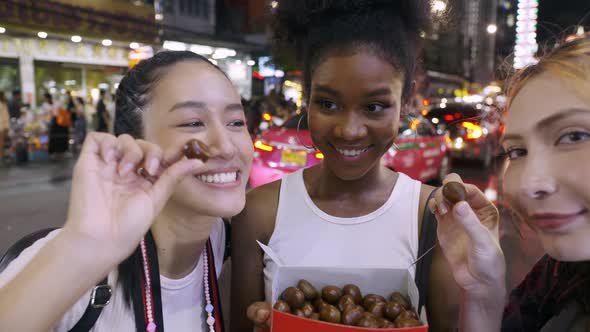 multi-ethnic female friends are enjoying a night out on Yaowarat Road or Chinatown in Bangkok