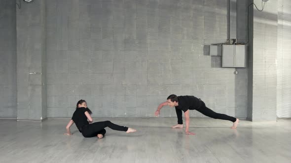 Skillful Dancers Practicing Modern Dance in Studio