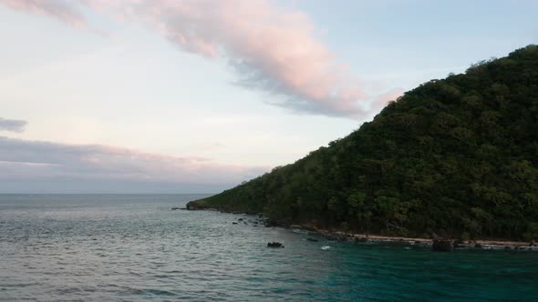 The Lush Green Naviti Island In Fiji Background With Cloudy Sky And Peaceful Ocean - Wide Shot