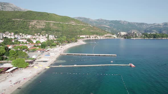 Aerial View Budva Beach By Sea with Sun Loungers and People Seashore Montenegro