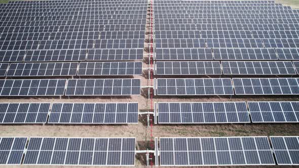 Hypnotic horizontal pattern, solar photovoltaic panel at a green energy facility, aerial