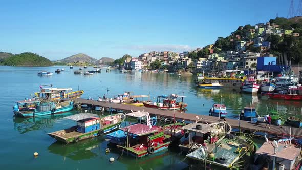 Drone crossing a pier full of boats in a beautiful sunny day - Vitória, Espírito Santo Brazil.