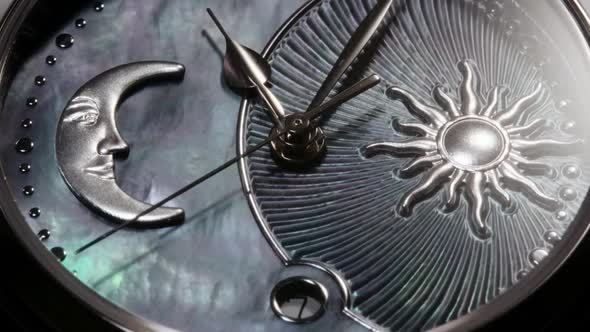 Rotating Swiss Watch with Sun and Moon Closeup